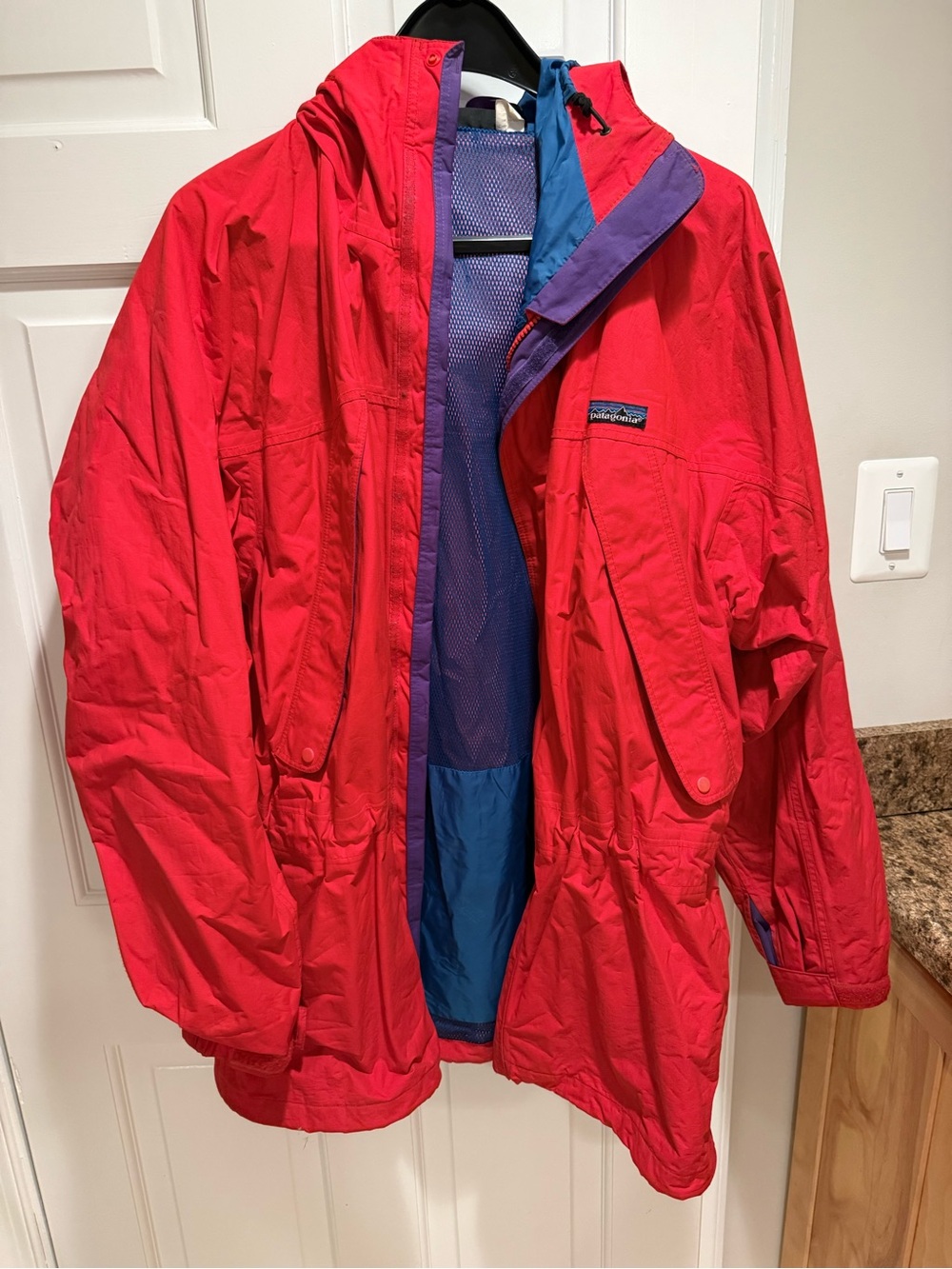 Patagonia Bright Red Raincoat with Blue and Purple Accents